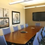 A large conference room with a big table and chairs