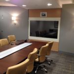 A conference room with a large table and chairs.