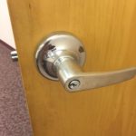 A door handle is shown with the lock on.