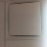 A square white tile on the wall