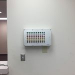 A wall mounted device with many different colors.