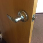 A door handle is shown with the lock on.