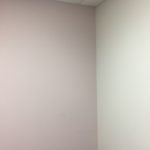 A corner of a room with white walls and a ceiling.