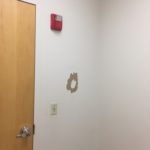 A fire alarm is on the wall of this room.