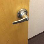 A door handle on the inside of a room.