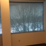 A window with a view of trees and snow.