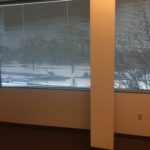 A window with a view of trees and snow.