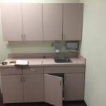 A small kitchen with an open cabinet door.