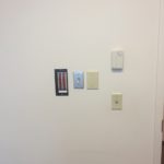 A wall with several different types of electrical switches.