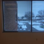 A view of the snow from inside a room.