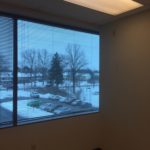 A view of a snowy landscape from the window.