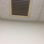 A vent in the ceiling of an office building.