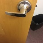 A door handle is shown on the inside of a room.