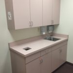 A kitchen with a sink and cabinets in it