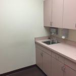 A kitchen with a sink and cabinets in it