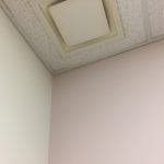 A ceiling with a white tile pattern on it