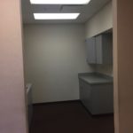 A room with a sink and cabinets in it