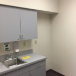 A kitchen with a sink and cabinets in it