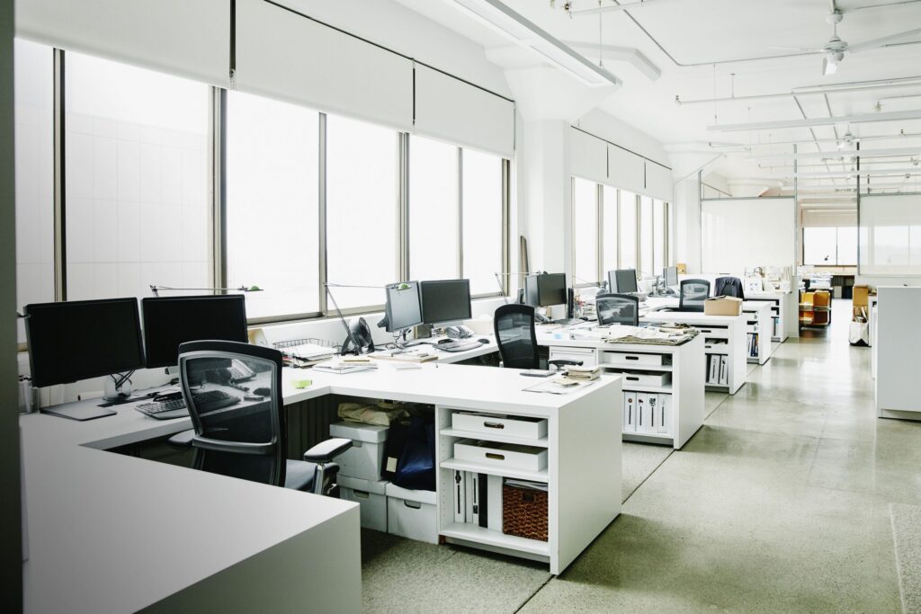 A large office with many desks and chairs.